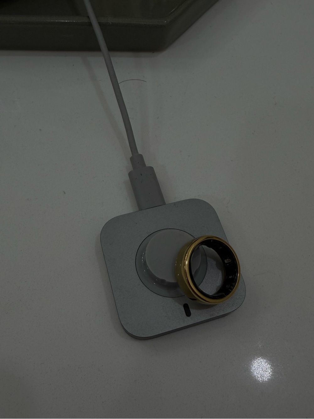 OURA RING GEN 3 with charger 
Gold Ring on Charger